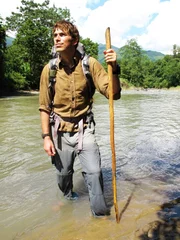 Picture Shows_Simon Reeve wading across a river in Western Burma - From 'Tropic of Cancer', first broadcast in 2010