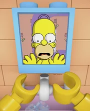 Als der Lego-Homer sein menschliches Spiegelbild sieht, dämmert ihm, dass die Legowelt nicht real ist und er irgendwie versuchen muss, in die Wirklichkeit und damit in seinen Körper aus Fleisch und Blut zurückzukehren ...