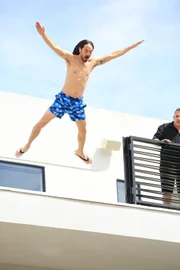 Steve Aoki jumping into his 16 foot pool.