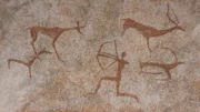 Drawing in a cave painted by an ancient man on a wall, a rock. Paints red ocher. Hunting for an animal., Neanderthal, cave man. The Stone Age, the Ice Age. Science, anthropology.