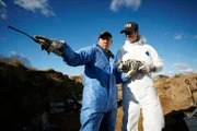 REENACTMENT - NTSB Investigator (played by (played by Byron Abalos) and another investigator stand in the crater created by the impact of the plane crash that killed world famous golfer Payne Stewart.