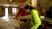 Ausbilder Wido Hahne zeigt den Mädchen von der Jugendbauhütte, wie man ein altes Fachwerkhaus denkmalgerecht saniert.