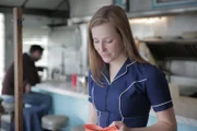 Waitress serving coffee at a diner.