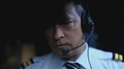 Air France pilot with headset on.