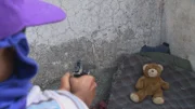 GUATEMALA CITY, GUATEMALA- El Chiquito shooting A toy bear.