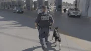 K9 Officer Sudaria makes his way to the primary lanes with his dog. (National Geographic)