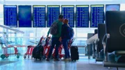 KYLE HUCKABEE and BAJAREE "NOON" BOONMA kiss before boarding their flight to Thailand.