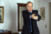 Kommissariatsleiter Peter Michael Schnabel (Martin Brambach) zielt mit seiner Waffe.