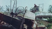 Ein amerikanischer M4 Sherman-Panzer fährt an einem zerstörten Fahrzeug vorbei, während er sich in Vorbereitung auf die Operation Shingle von der Gustav-Linie entfernt. (Lou Reda Productions)