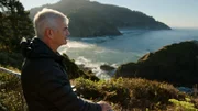 Archaeologist and Anthropologist, Professor Loren Davis, stands at Heceta Head Lighthouse viewpoint looking out over the Oregon coast. (National Geographic/Mark Molesworth)