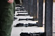 Nogales, Arizona, USA: Weapons lined up on the ground at the firing range where Customs and border protection agents train.