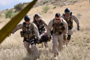Nogales, Arizona, USA: Officers carry an injured immigrant to the blackhawk. Immigrants trying to enter the country illegally walk through the desert for days putting themselves at risk for dehydration and death.
