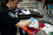 Jamaica, New York, USA: A CBP Agricultural specialist inspecting a passenger's luggage. (Photo Credit: National Geographic Television)