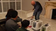 Jackson Galaxy presenting litter boxes to the family.