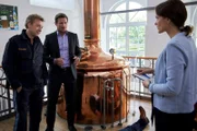 Der Chef der Firma "Bartlbräu" wurde tot in seiner eigenen Brauerei aufgefunden. Pathologin Mai (Sina Wilke, r.) klärt Kommissar Hansen (Igor Jeftic, M.) und Polizeihauptmeister Mohr (Max Müller, l.) über die Todesursache auf.