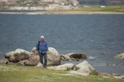 Landscape, WS of Jeremy Wade walking on the shores of Copeton Dam.
