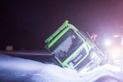 Overhalla, Norway - Truck in the ditch. A lot of snow. Ole Henrik Blengsli is climbing on it to get an overview of the situation.