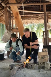 Rewa, Guyana - Rovin Alvin, an Amerindian fishing guide, teaches Gordon Ramsay how to make a bow and arrow used to catch Arowana, a freshwater bony fish. (National Geographic/Justin Mandel)