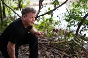 Rewa, Guyana - Gordon Ramsay cooks a tarantula for a quick snack while his freshly caught black piranha are grilling. (Credit: National Geographic/Justin Mandel)