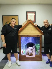 Wayde King, Brett Raymer and the client with the completed dog house tank.