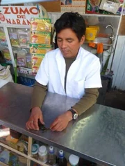 Arequipa, Peru: Hector, owner of a frog juice stand, holds out a live frog. He and his wife Evelyn breed frogs especially for the making of frog juice, which is believed to have remedial properties.