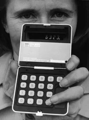 Closeup of a woman displaying a new calculator during an electronics exposition, April 29, 1975. (Photo by Archive France/RDA/Getty Images)  NO MODEL RELEASES FOR IMAGE.