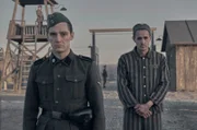 Jonas Nay as Nazi Officer Stefan Baretzki & Jonah Hauer-King as Lali Sokolovin in Auschwitz.