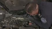 CBP Officer Felix discovers packages hidden under the hood of a car. (Credit: National Geographic)