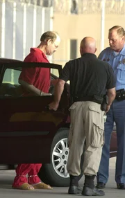 Dennis L. Rader (L), the man admitting to be the BTK serial killer, is escorted into the El Dorado Correctional Facility on August 19, 2005 in El Dorado, Kansas.