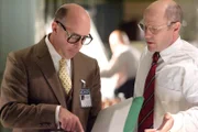 Investigator Caj Frostell (Robert B. Kennedy) at right, reviews files with a collaborator.