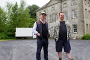 Host; Drew Pritchard and Assistant; John Tee; standing in front of Roundwood House