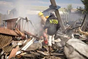 REENACTMENT: Clint Crookshanks (played by Jason Weinberg) and a firefighter navagate through the smouldering wreckage of a Bombardier commercial jet to locate and retrieve the black boxes from the flight, which mysteriously fell from the sky minutes from landing at Buffalo's airport.