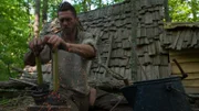 MARS HILL, N.C.- Thorn using his homemade billows to get his fire going next to his home.