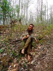 MARS HILL, N.C.- Thorn sitting on a hillside, barefoot. (Photo Credit: NG Studios/Chris Najmi)