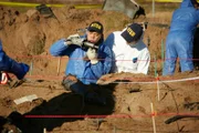 REENACTMENT - NTSB Investigator (played by Byron Abalos) examines a piece of wreckage discovered  at the site of world famous golfer Payne Stewart's fatal plane crash.