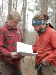 Pete Nelson discussing the building plans with a builder.