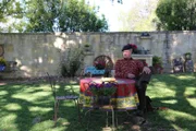 Pete Nelson sitting at a table under the tree before the treehouse build.