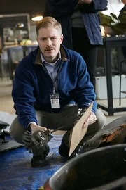 RE-CREATION:  Tom Haueter (played by Danny Deakin) holds up a piece of the wreckage and contemplates what may have gone wrong.   (photo credit:  Cineflix/Ian Watson)