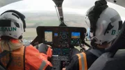 Rachel and Pilot Harry sitting in the font of the helicopter.