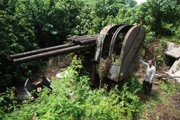 MICRONESIA - Tony Pollard posing with an anti-aircraft gun.