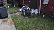 Dr. Rhett examines an electrical outlet outside.