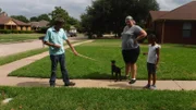 Adopters with Yahtzee outside of home during a home check.