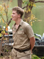 Robert Irwin standing near riverbank edge.