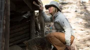 Misty Bilodeau assessing the pre-existing structure for where she wants to build a livestock pen at the Ettinger Homestead in Wolf Creek, Montana.