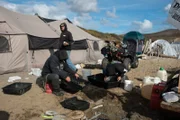Andy Kelly, Kris Kelly, and Brad Kelly cleaning gold on the beach.