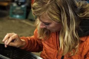 Emily Riedel looking in gold pan.