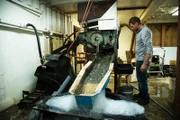 Shawn Pomrenke in the clean out shack looking at sluice.