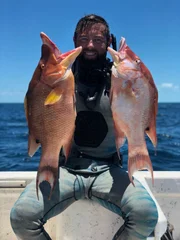 Forrest Galante with two pink fish he caught.