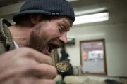 Shawn Pomrenke pretending to eat a spoonful of gold.