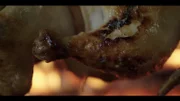 Rotisserie chicken over fire.